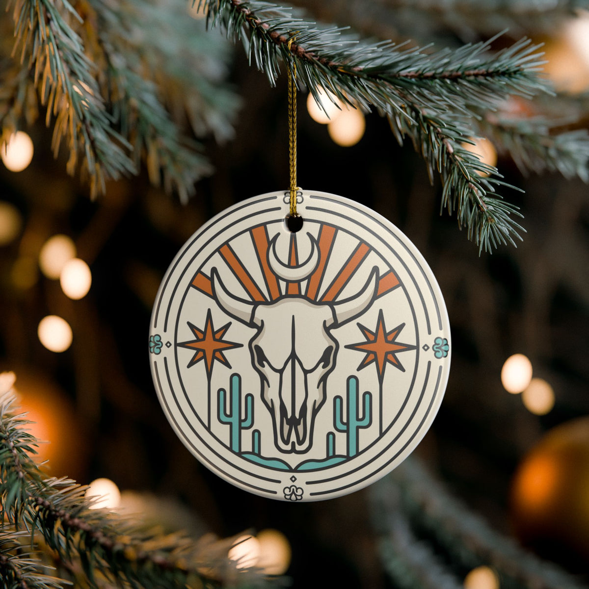 Western bull skull ceramic Christmas ornament with desert sunburst and cacti
