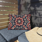Red and navy paisley medallion outdoor lumbar pillow on patio seating