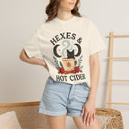 Black cat perched on a hot cider mug with moons and harvest accents on a fall T-shirt