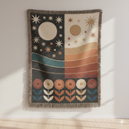 Celestial day-and-night woven blanket displayed on a wall