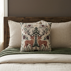 Christmas deer and cardinal woven pillow styled on a bed
