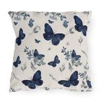 Blue butterfly outdoor pillow with botanical details on cream