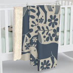 Navy Dala horse and floral sherpa blanket displayed on a crib