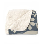 Folded navy and cream Dala horse blanket with plush backing