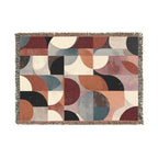 Mid-century geometric woven blanket with rust teal blush and cream shapes