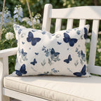 Blue butterfly outdoor pillow styled in a garden seating area