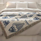 Blue Scandinavian folk fish woven blanket with cream background and fringe
