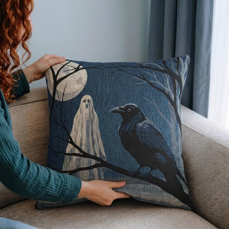 Person placing a ghost and raven woven Halloween pillow on a sofa
