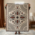 Black and rust Western boot stitch woven throw blanket on a natural woven base