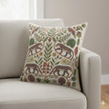 Jaguar and tropical bird folk art pillow styled on a white armchair