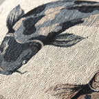 Close-up of the textured weave on the indigo and tan koi fish pillow