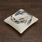Koi fish woven throw pillow shown at an angle on a wood floor