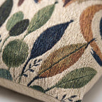 Earth-tone botanical woven pillow in terracotta, olive and cream