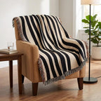 Abstract black and cream zebra stripe woven throw styled on a chair