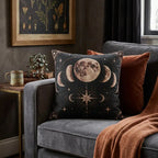 Warm bronze moon phases woven pillow styled on a dark gray chair