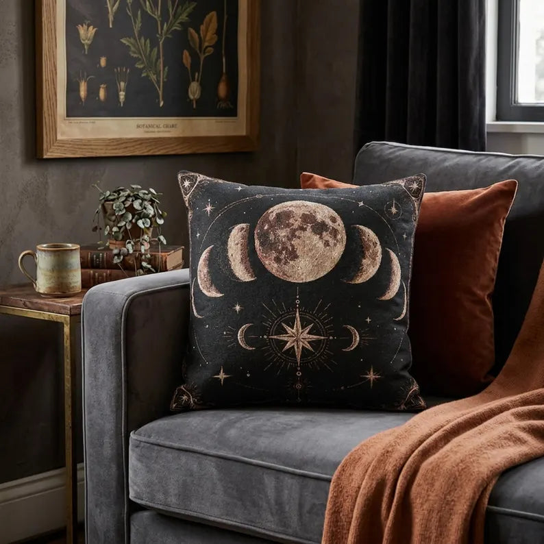 Celestial moon phases pillow with compass star in a moody reading nook
