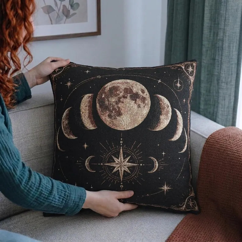Person holding the 17 by 18 inch warm moon phases woven pillow for scale