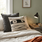 Mummy eyes woven Halloween pillow styled in a bedroom