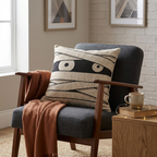 Mummy eyes woven Halloween pillow shown at realistic chair scale