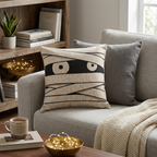 Mummy eyes woven Halloween pillow styled on a sofa
