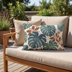 Tropical monstera outdoor pillow styled on patio furniture
